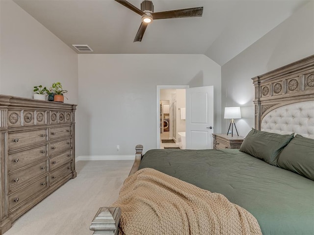 carpeted bedroom with ceiling fan, ensuite bathroom, and lofted ceiling