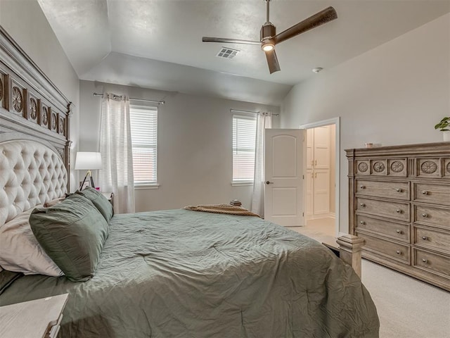 carpeted bedroom with ceiling fan and vaulted ceiling