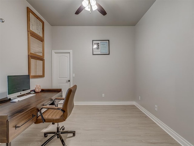 office space with light hardwood / wood-style floors and ceiling fan