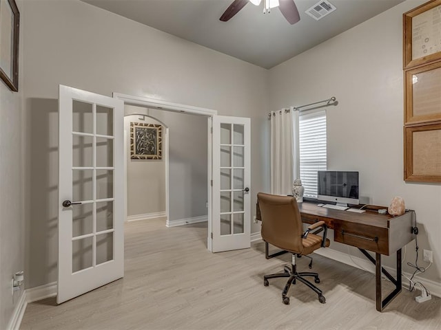 home office with ceiling fan, french doors, and light hardwood / wood-style floors