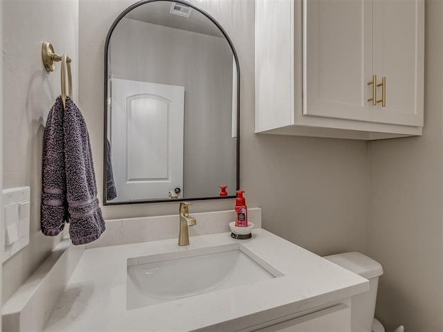 bathroom with toilet and vanity