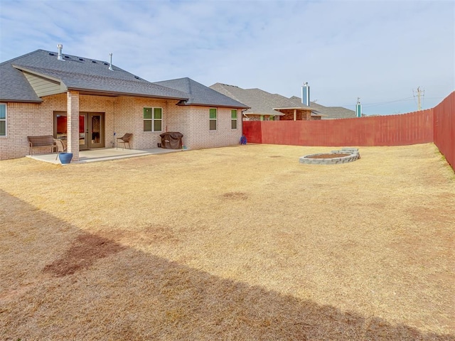 exterior space with an outdoor fire pit and a patio