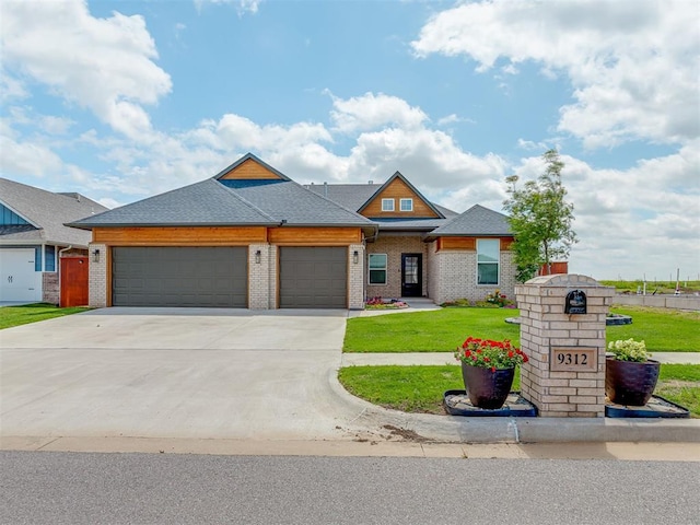 9312 Taggert Ln, Yukon, OK 73099 - view of front of house with a garage, a front yard, brick siding, concrete driveway, and roof with shingles