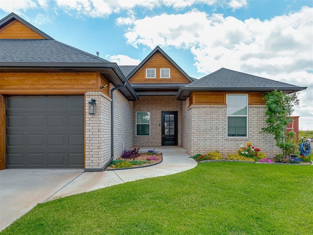 9312 Taggert Ln, Yukon, OK 73099 - view of front of house featuring brick siding, a front yard, an attached garage, driveway, and a shingled roof