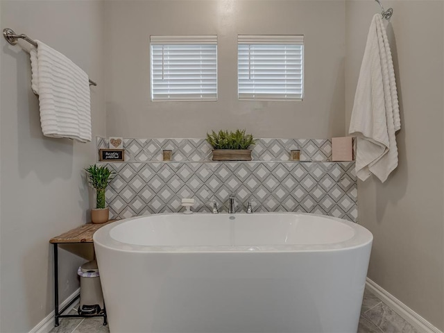9312 Taggert Ln, Yukon, OK 73099 - full bathroom featuring a freestanding tub and baseboards