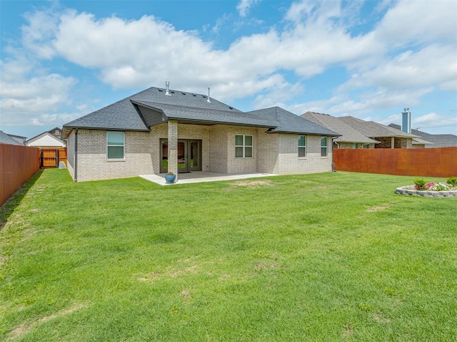 9312 Taggert Ln, Yukon, OK 73099 - rear view of house with a patio, a shingled roof, and brick siding