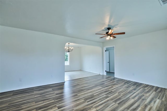 empty room featuring ceiling fan with notable chandelier and wood-type flooring