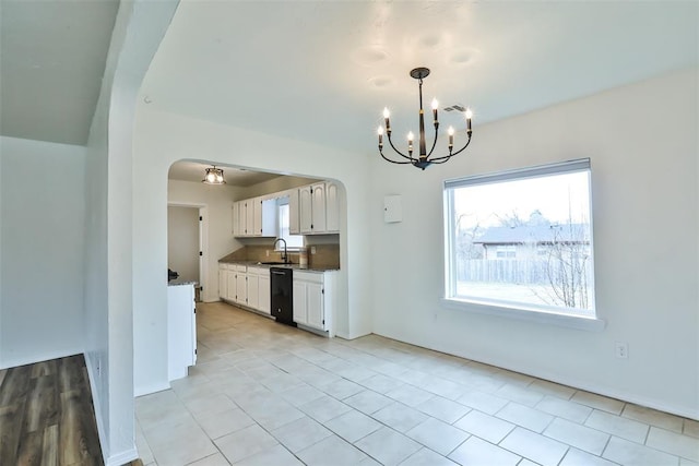 kitchen featuring white cabinetry, a notable chandelier, dishwasher, hanging light fixtures, and sink