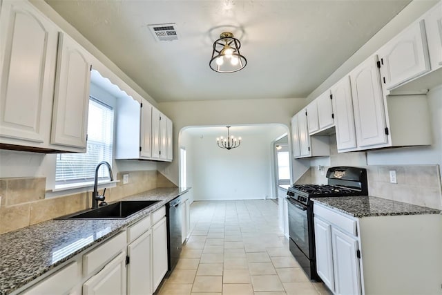 kitchen featuring pendant lighting, black appliances, white cabinetry, dark stone countertops, and sink