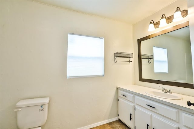 bathroom featuring tile patterned floors, toilet, and vanity