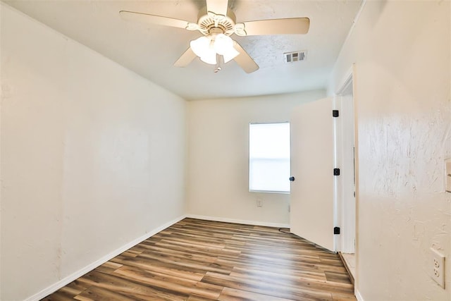 empty room featuring ceiling fan and hardwood / wood-style flooring