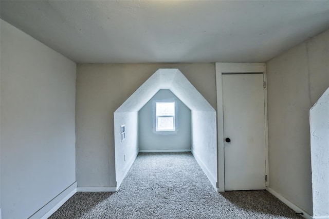 bonus room featuring carpet floors and vaulted ceiling