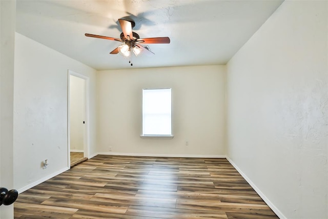 unfurnished room featuring ceiling fan and dark wood-type flooring