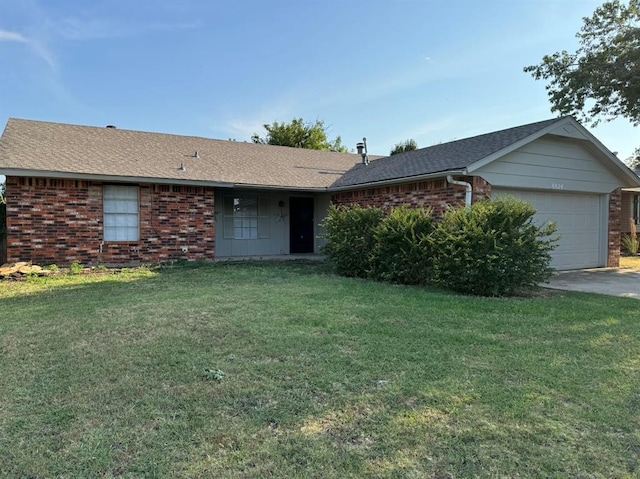 ranch-style home with a garage and a front lawn