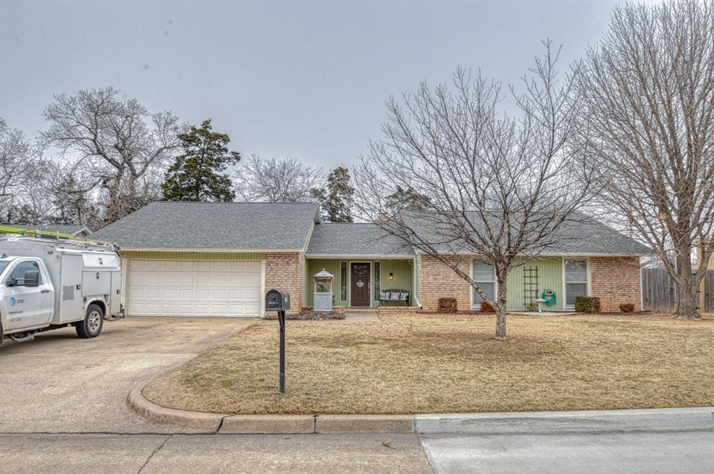 single story home featuring a front yard and a garage