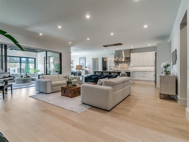 living room featuring light hardwood / wood-style floors and sink