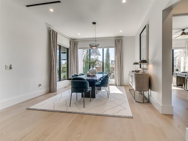 dining area featuring plenty of natural light, a chandelier, and light hardwood / wood-style floors