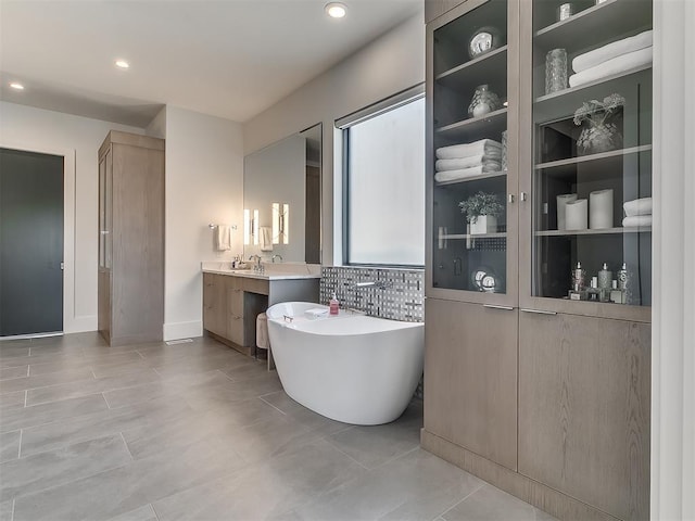 bathroom featuring a bath and vanity