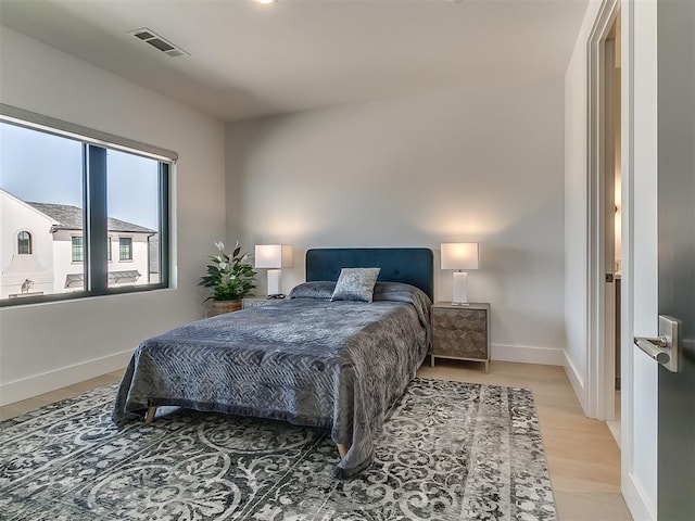 bedroom with hardwood / wood-style flooring