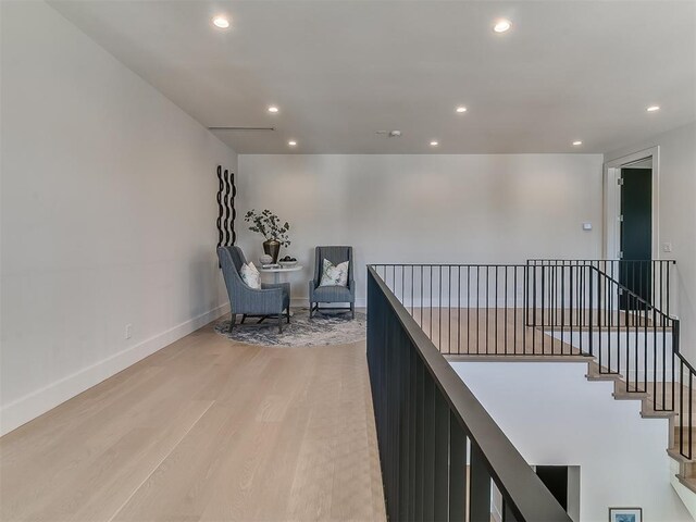 corridor with light hardwood / wood-style flooring