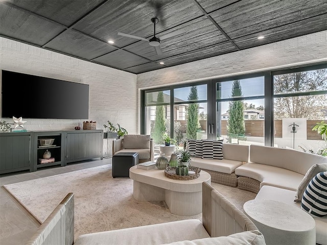 living room with ceiling fan and a wealth of natural light