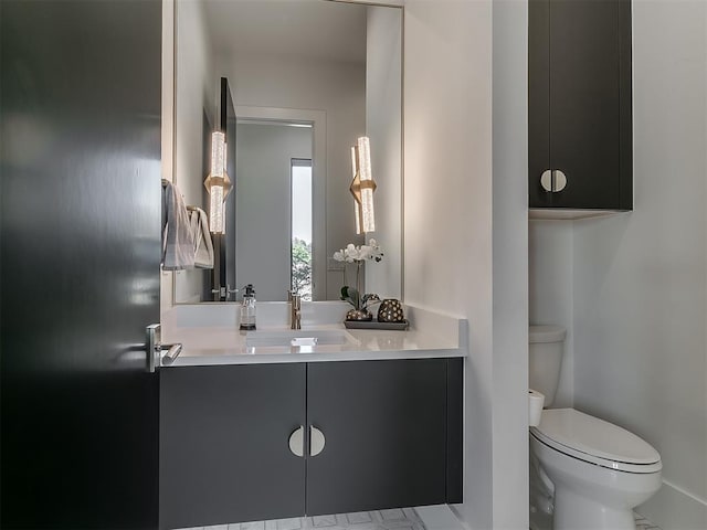 bathroom featuring toilet and vanity