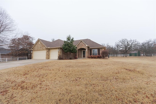 ranch-style home with a garage and a front lawn