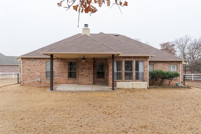 back of house with ceiling fan and a patio area