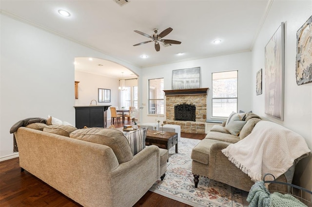 living room with ceiling fan, ornamental molding, dark hardwood / wood-style flooring, and a wealth of natural light