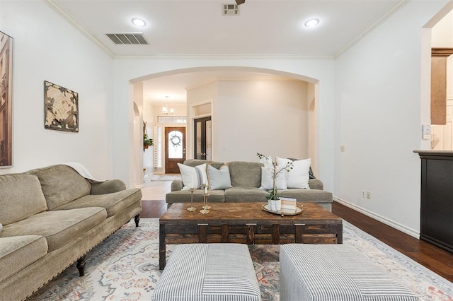 living room with ornamental molding and hardwood / wood-style floors