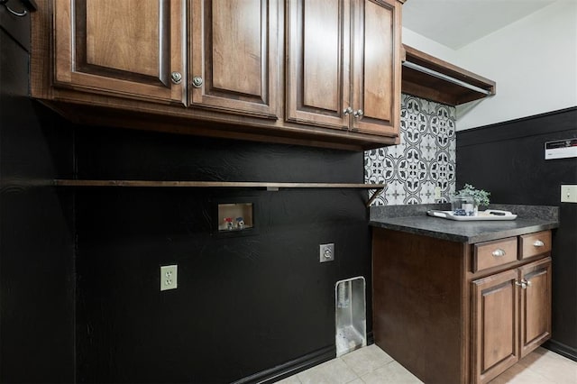 kitchen with light tile patterned flooring and dark brown cabinetry