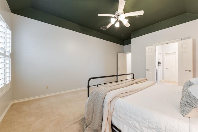 bedroom featuring lofted ceiling, light colored carpet, and ceiling fan