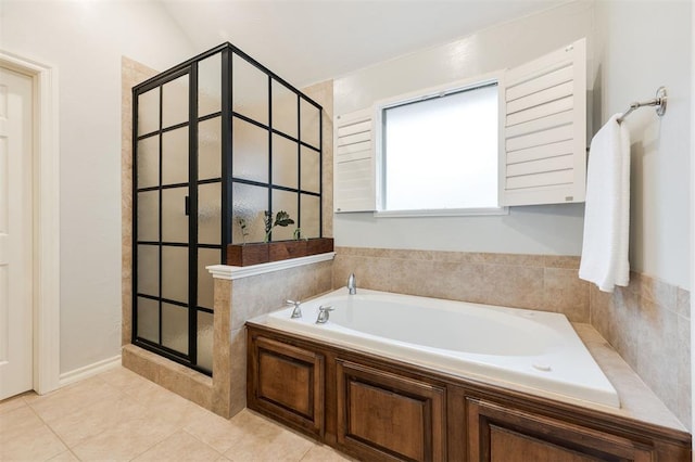 bathroom with tile patterned floors and independent shower and bath