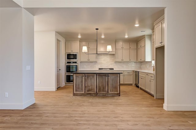 kitchen with decorative light fixtures, decorative backsplash, light hardwood / wood-style flooring, and built in microwave