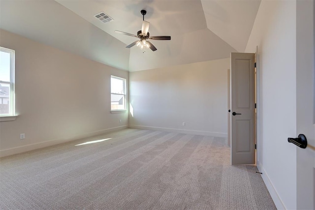 carpeted spare room with ceiling fan and lofted ceiling