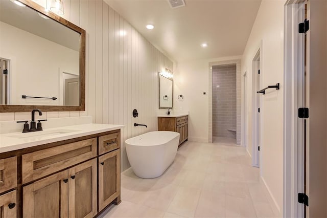 bathroom featuring independent shower and bath, tile patterned floors, and vanity