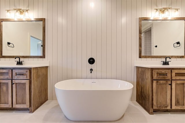 bathroom with a tub to relax in, vanity, and wooden walls