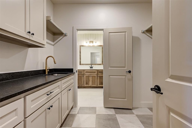 kitchen featuring sink and white cabinetry