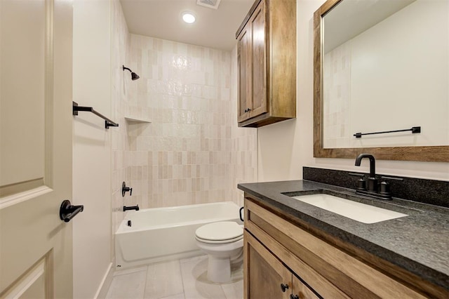 full bathroom featuring toilet, tile patterned flooring, tiled shower / bath, and vanity