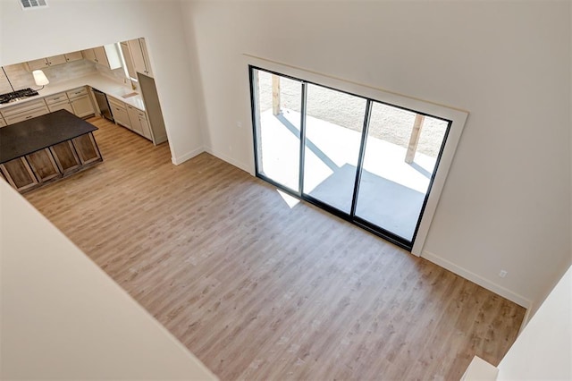 living room featuring sink and light wood-type flooring