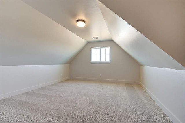 bonus room featuring light colored carpet and lofted ceiling