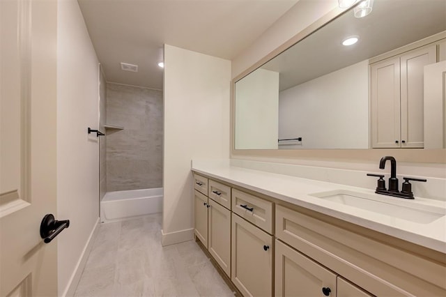 bathroom with tile patterned flooring, tiled shower / bath combo, and vanity