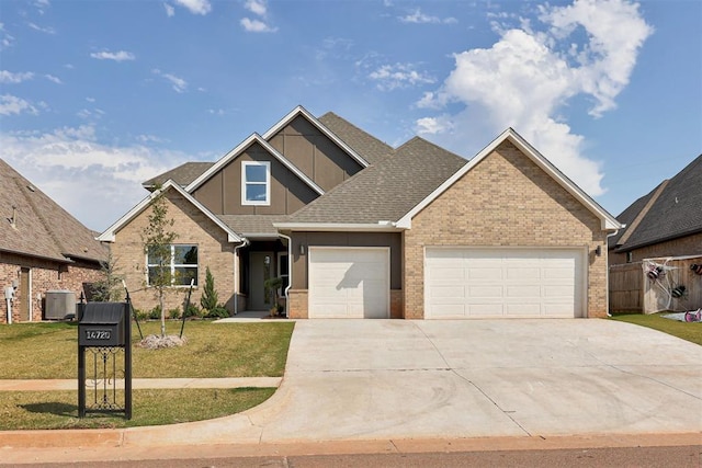 craftsman house featuring a garage, a front yard, and central AC unit