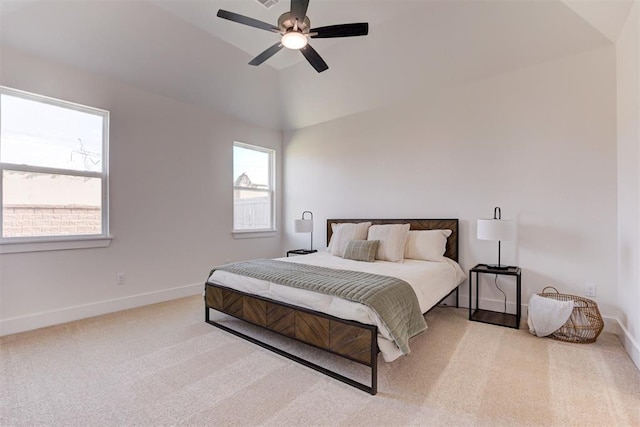 carpeted bedroom with ceiling fan and vaulted ceiling