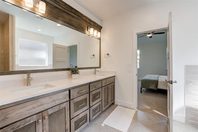 bathroom featuring a wealth of natural light, vanity, and tile patterned flooring