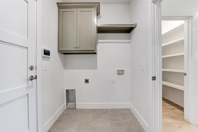 washroom with washer hookup, hookup for an electric dryer, and cabinets