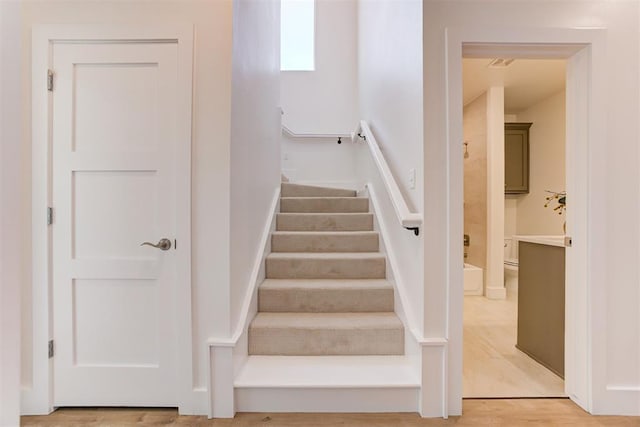 staircase featuring hardwood / wood-style floors