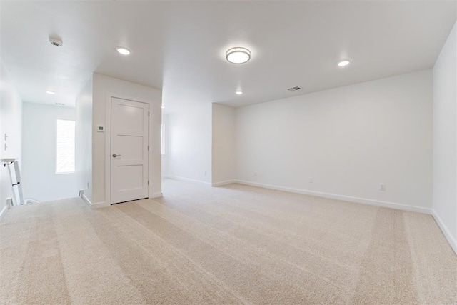 empty room featuring light colored carpet