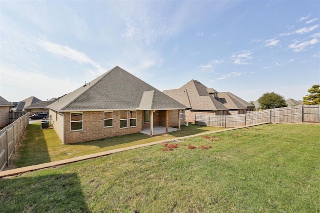 back of property with a patio and a yard