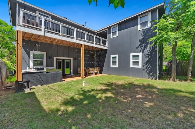 rear view of property featuring a yard and french doors